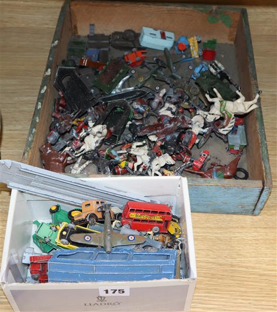 A quantity of farmyard animals and toy cars